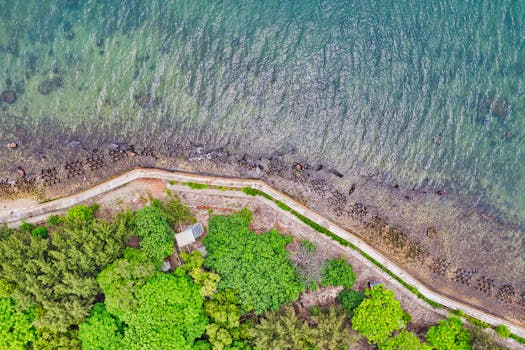 Stunning aerial image of a coastal road and lush greenery in South Kepulauan Seribu, Jakarta.