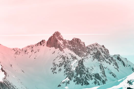 A stunning view of snow-capped mountains at sunrise, offering a blend of tranquility and beauty.