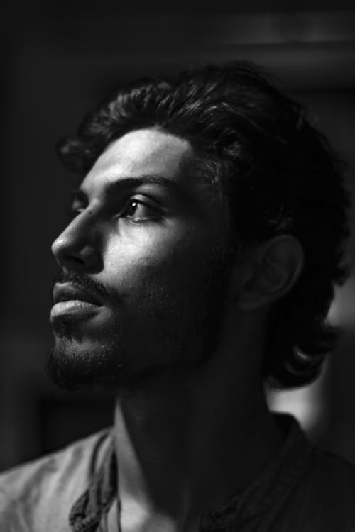 A black and white photo of a man looking up