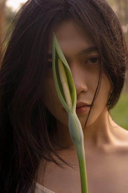 Young Woman Holding a Plant 