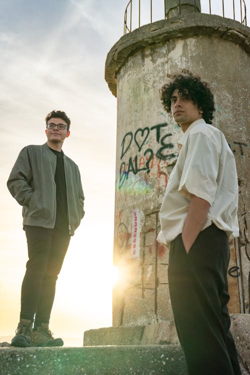 Two young men posing during sunset