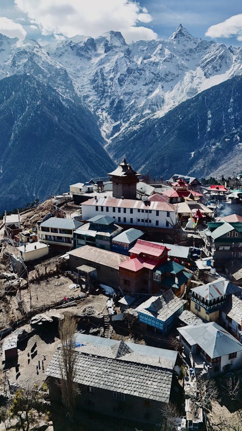 A village in the mountains with snow capped mountains