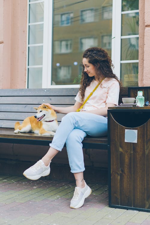 A Woman with a Dog on a Bench