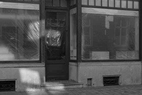 Black and White Photo of Exterior of an Abandoned Shop 