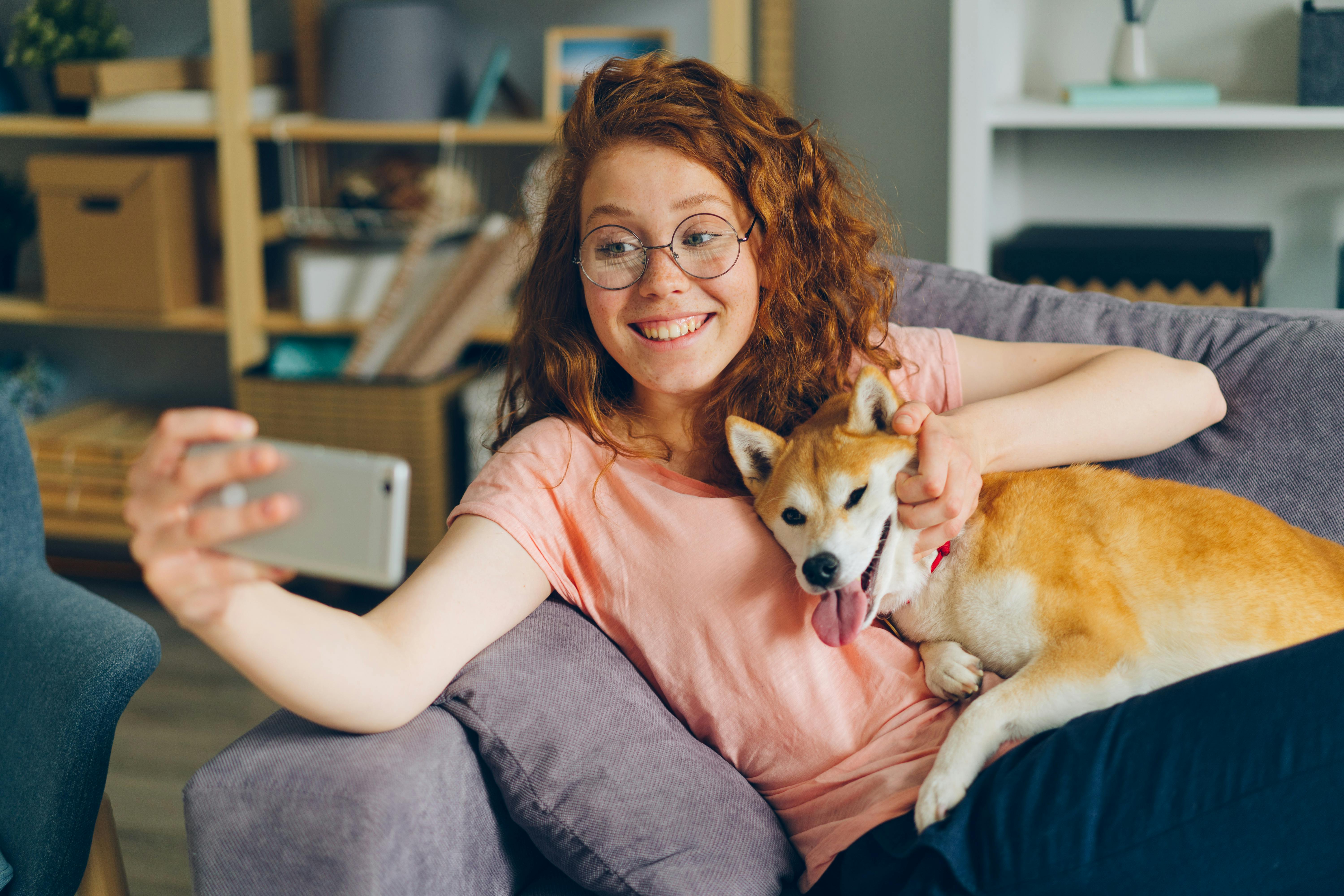 A Woman Taking a Selfie with Her Shiba Inu Dog 