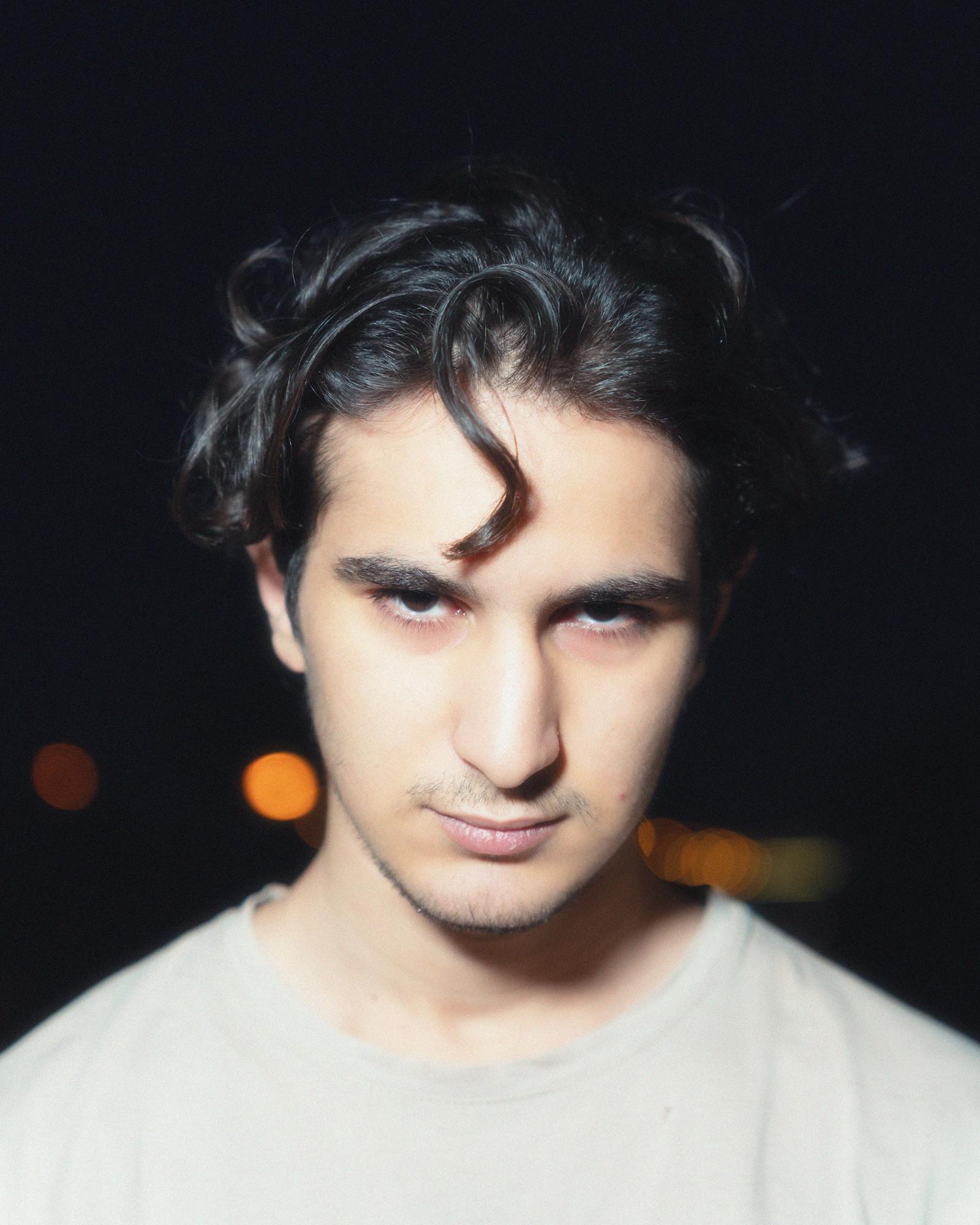 Direct-flash night street portrait with bright skin and hard-edge shadows in a Y2K style