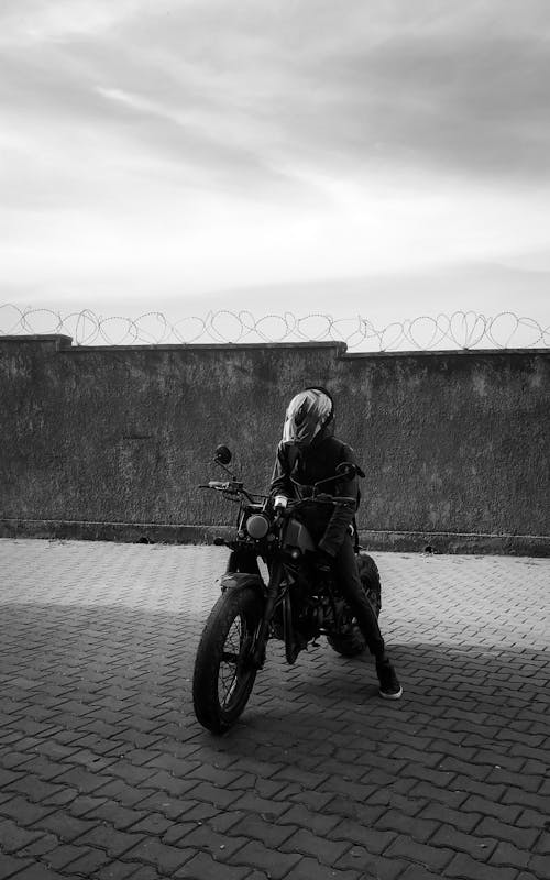 Free A person on a motorcycle in a black and white photo Stock Photo