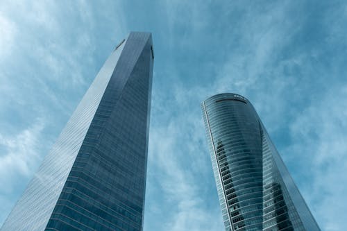 Two tall buildings with blue sky in the background