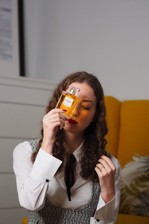 A woman is holding a bottle of whiskey