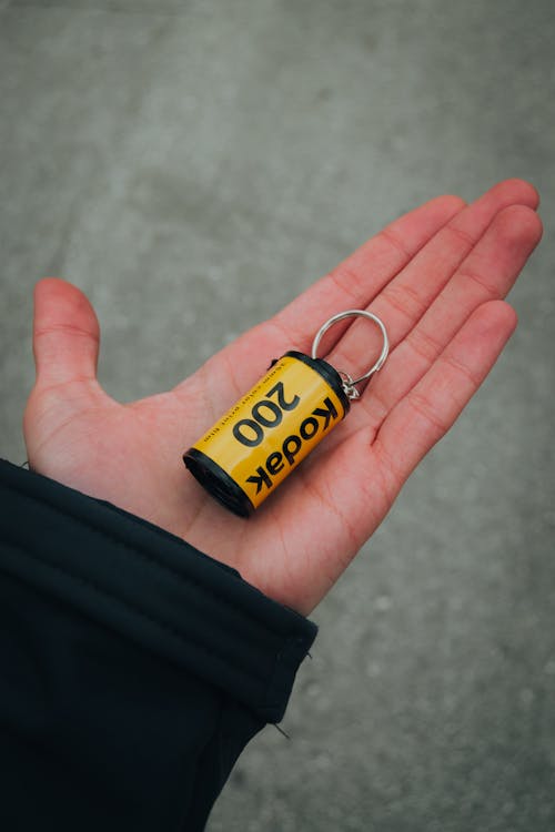 A person holding a keychain with the words, 100,000