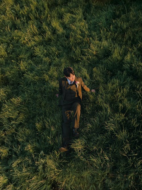 character sitting on the blades of grass in three piece suit   |  @lostintespace • by Amaan 