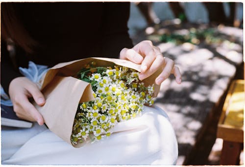 Close-up of a Woman Holding a Bunch of Flowers