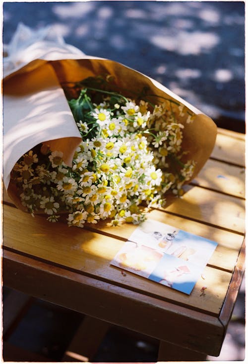 A bouquet of flowers sitting on a wooden table