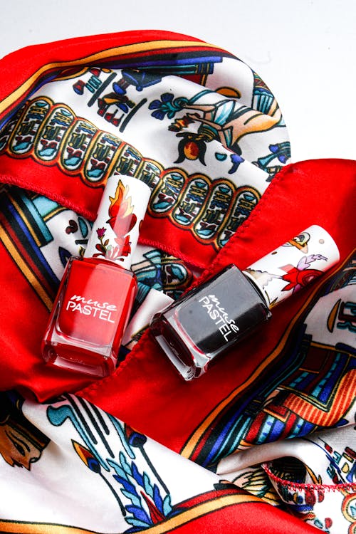 A red scarf and nail polish bottles