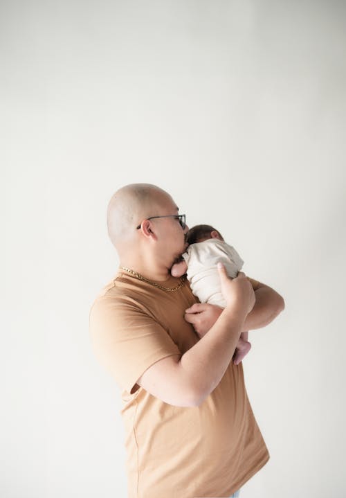 Portrait of Father Holding Baby