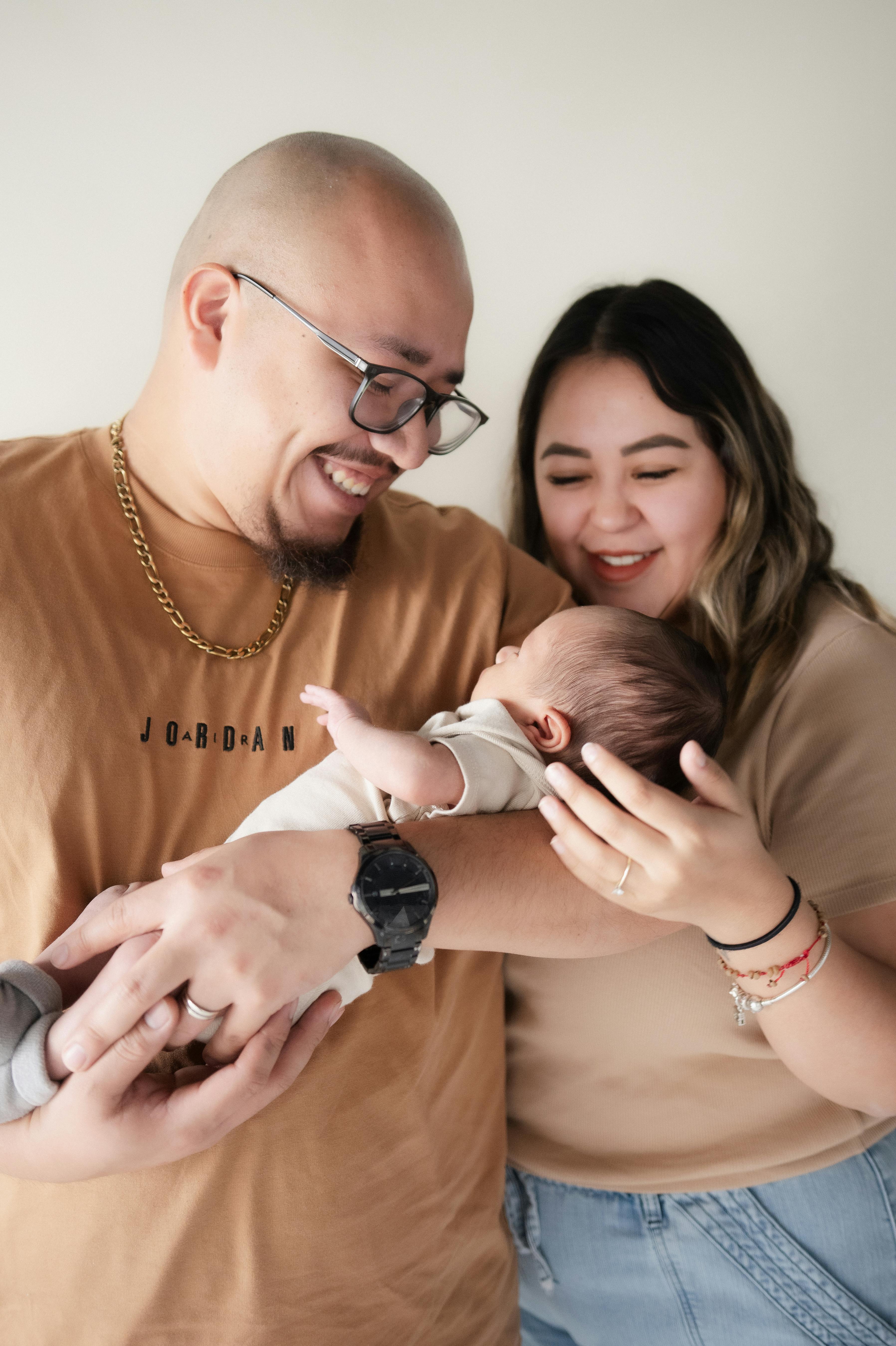 parents holding their newborn baby