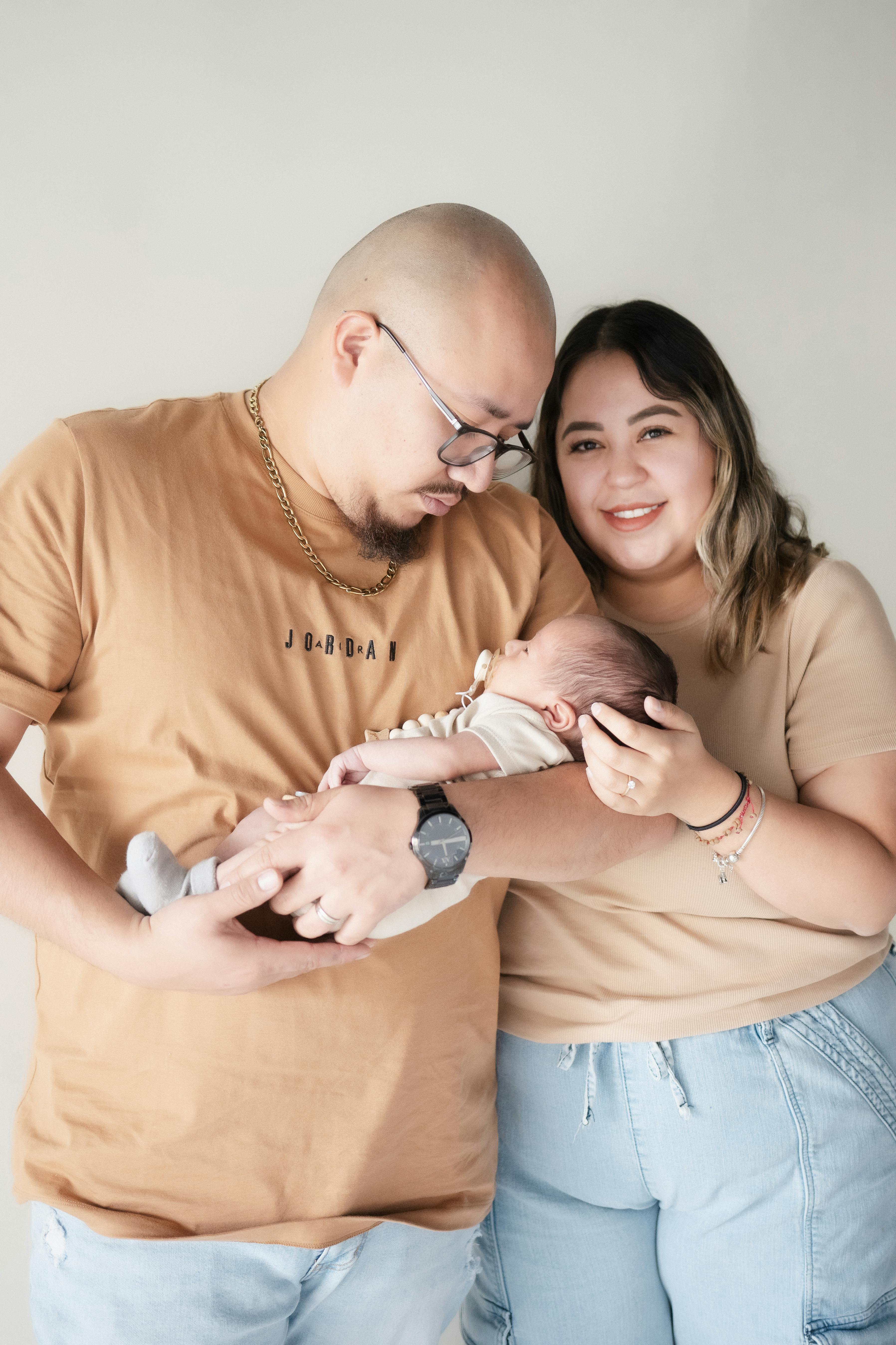 parents holding their newborn baby