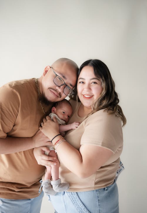 A man and woman holding a baby in their arms