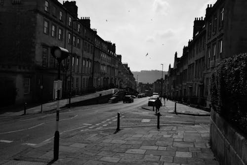 Black and white photo of a street with cars