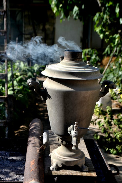 A large metal pot with smoke coming out of it