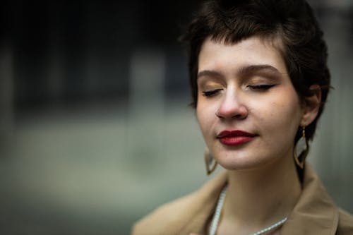 A woman with short hair and a necklace