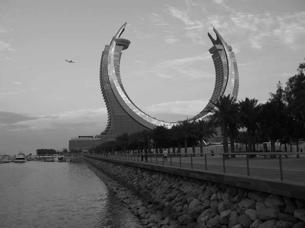 A black and white photo of a building with a large arch