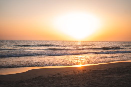 Breathtaking sunset vista over Cádiz beach with gentle waves and golden sky reflection.