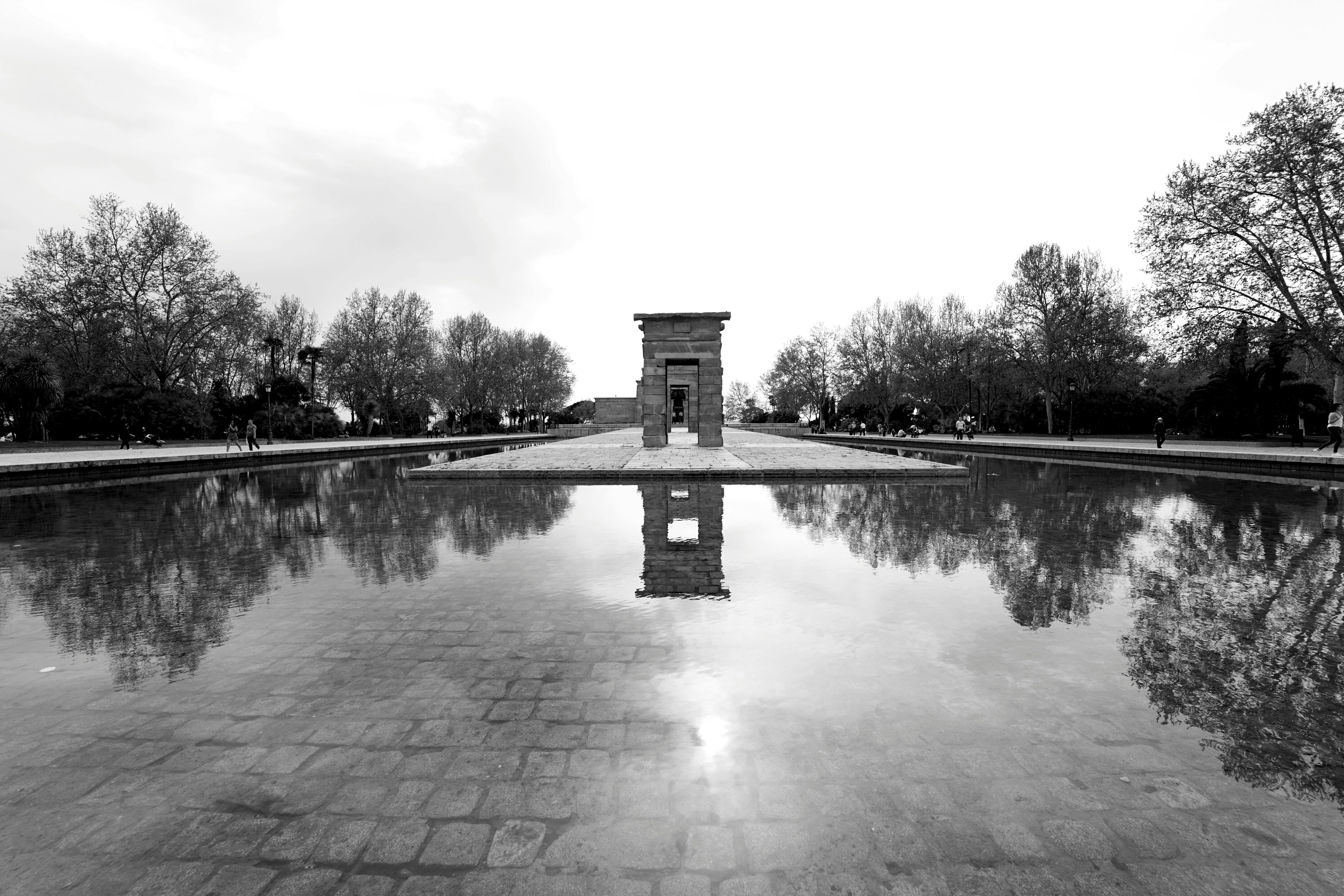 Reflective view of the Temple of Debod in Madrid, Spain, captured in black and white.