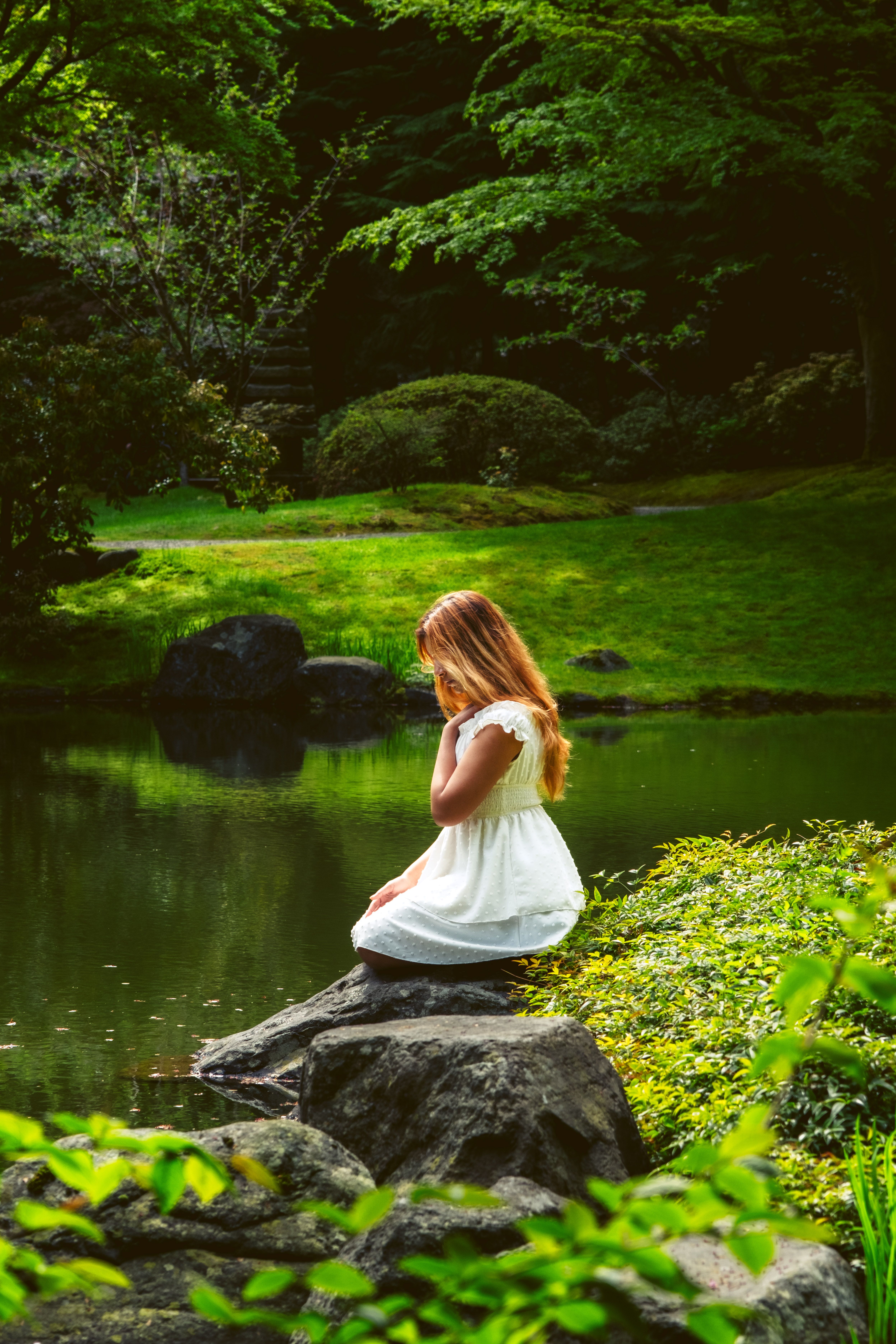 Woman in White Dress Sitting by River in Forest · Free Stock Photo