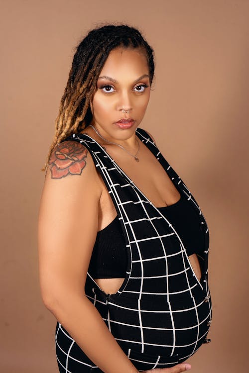 A pregnant woman in a black and white checkered dress