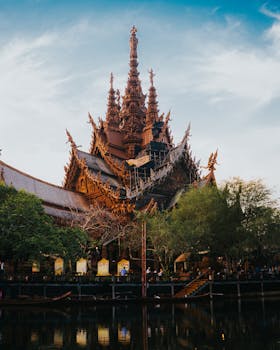Magnificent wooden Sanctuary of Truth temple reflecting Thai architectural beauty in Bangkok.
