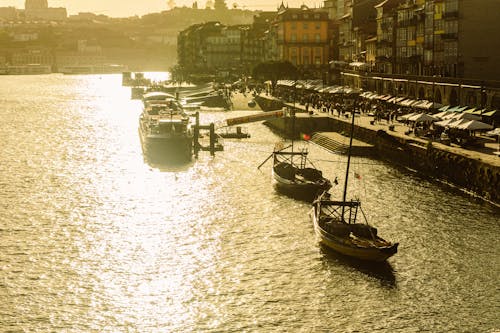 A boat is docked in a harbor at sunset