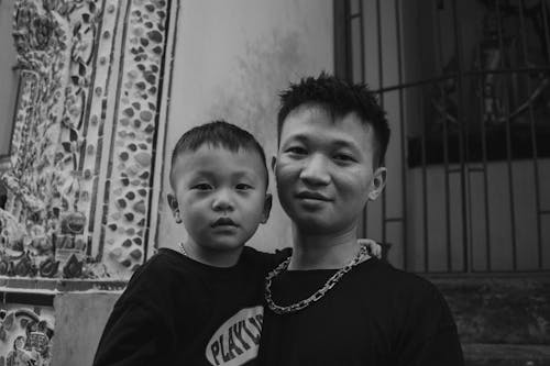 A black and white photo of a man and child
