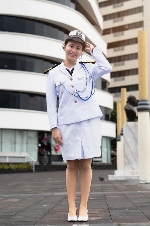 A woman in uniform standing on a street