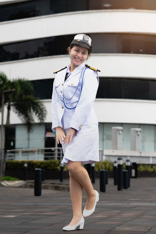 A woman in a white uniform posing for a picture