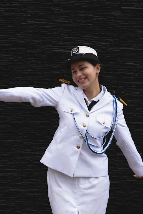 A woman in a sailor uniform is posing