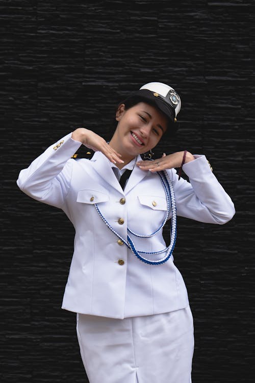 A woman in a sailor uniform posing for a photo