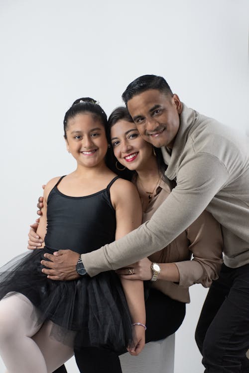 A family posing for a photo in a studio