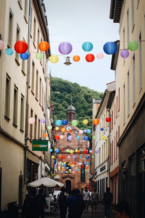 A street with colorful paper lanterns hanging from the ceiling