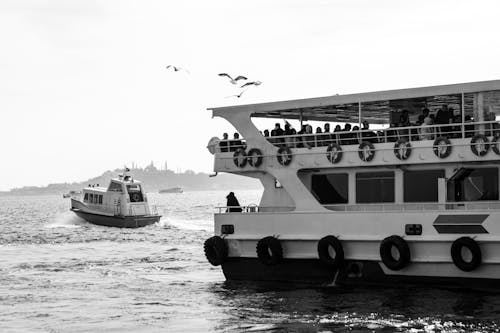 A black and white photo of a boat with people on it