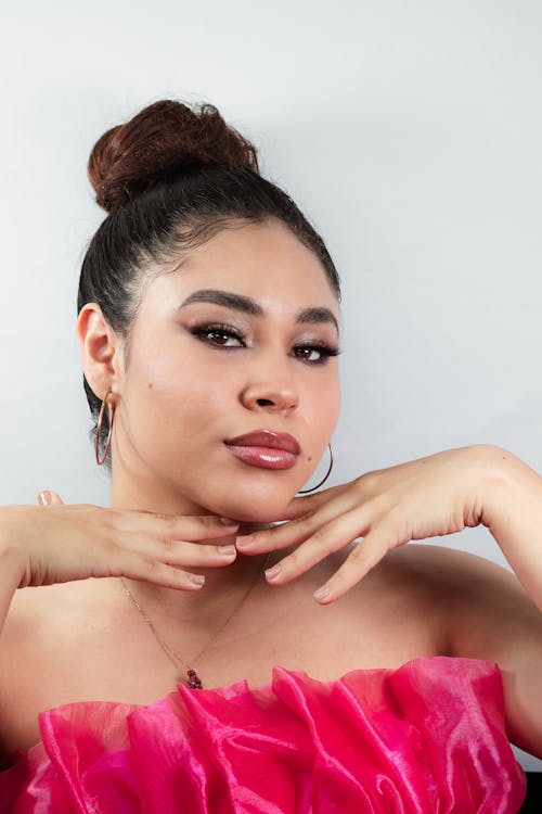 A woman in a pink dress posing for a photo