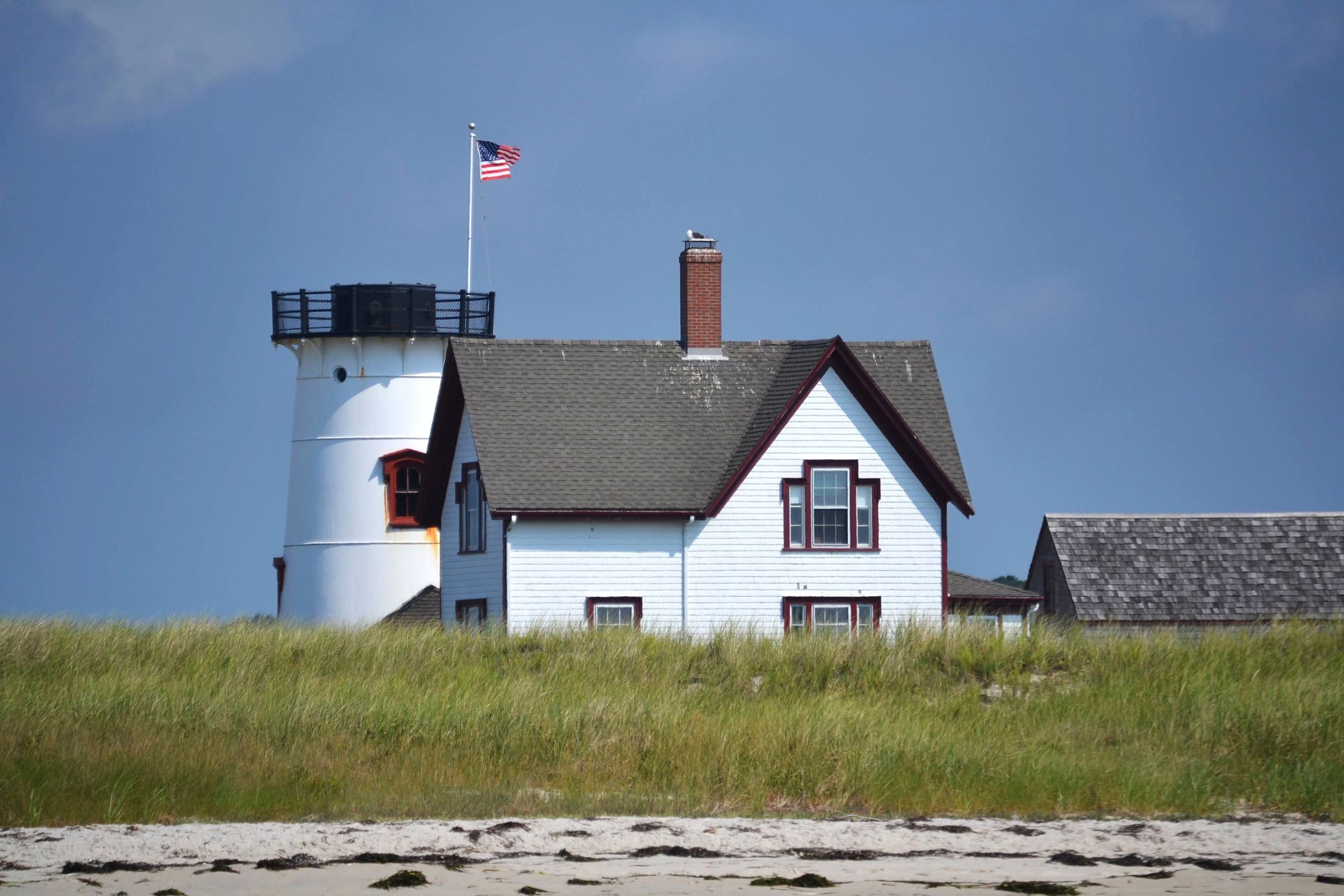 Historic Stage Harbor Lighthouse in scenic Chatham landscape.