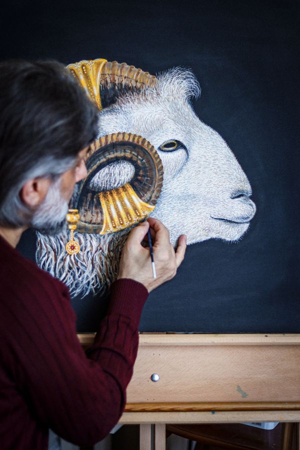 Free Artist skillfully painting a Capricorn symbol on canvas, featuring intricate ram depiction. Stock Photo
