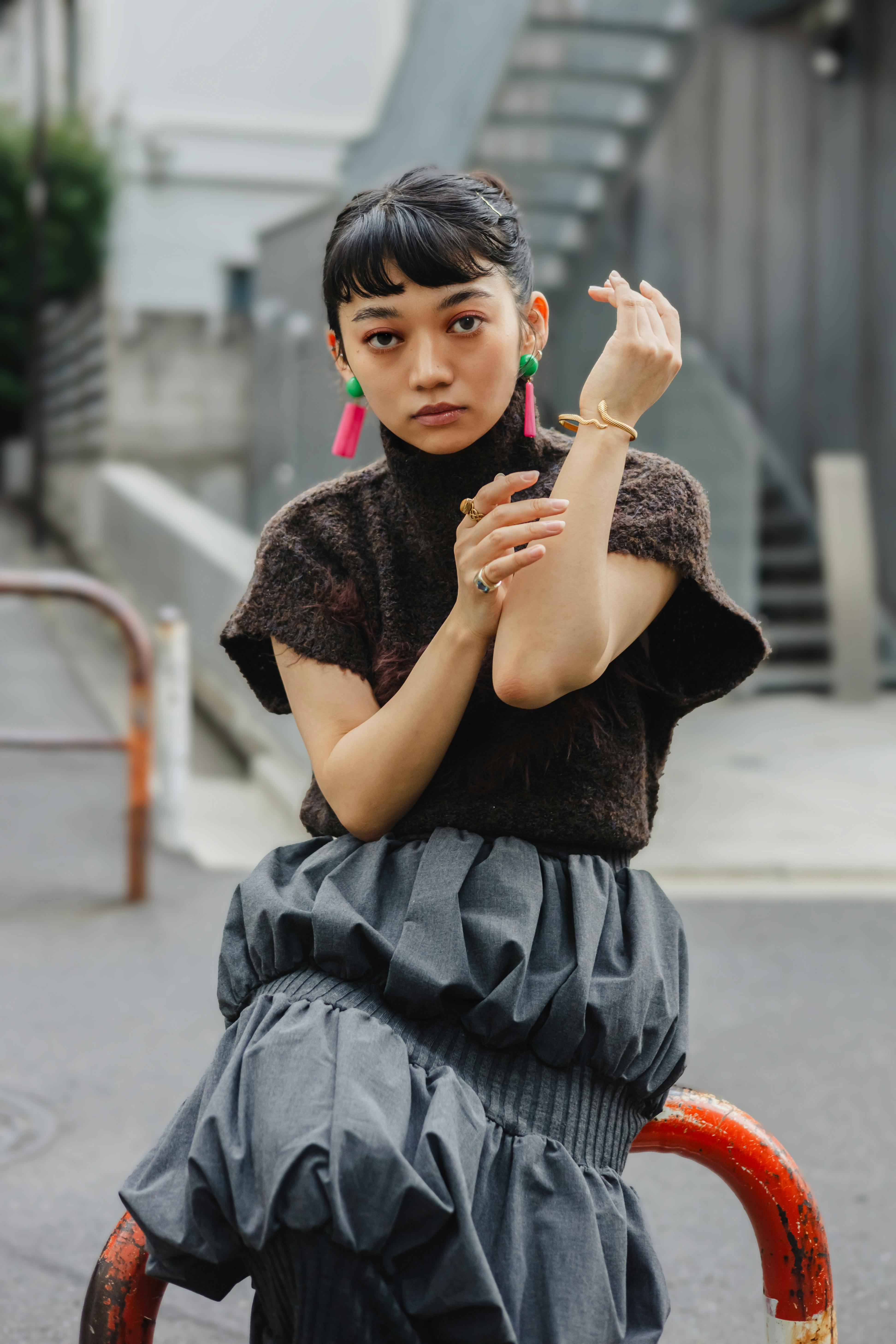 Stylish portrait of an elegant woman posing outdoors in Tokyo, Japan.