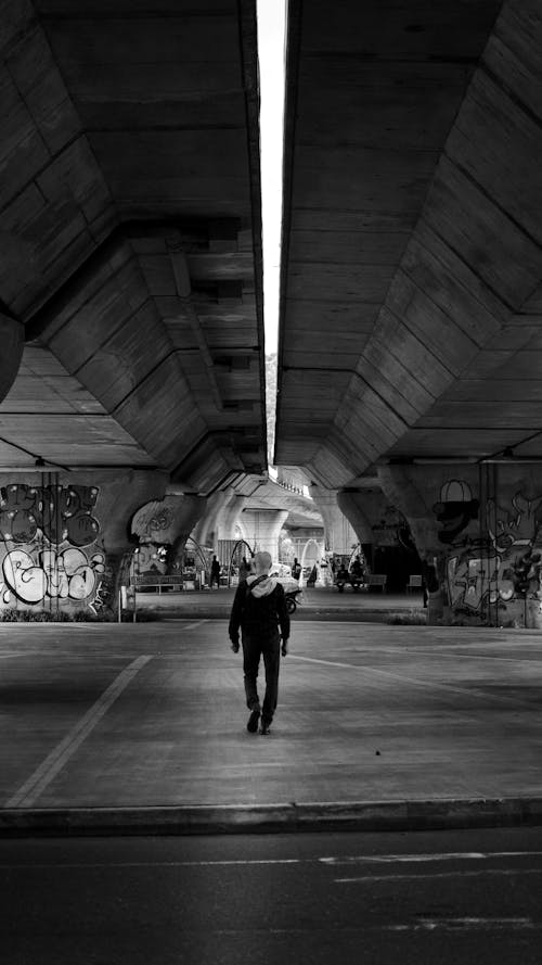 Back View of a Person Walking in a Tunnel