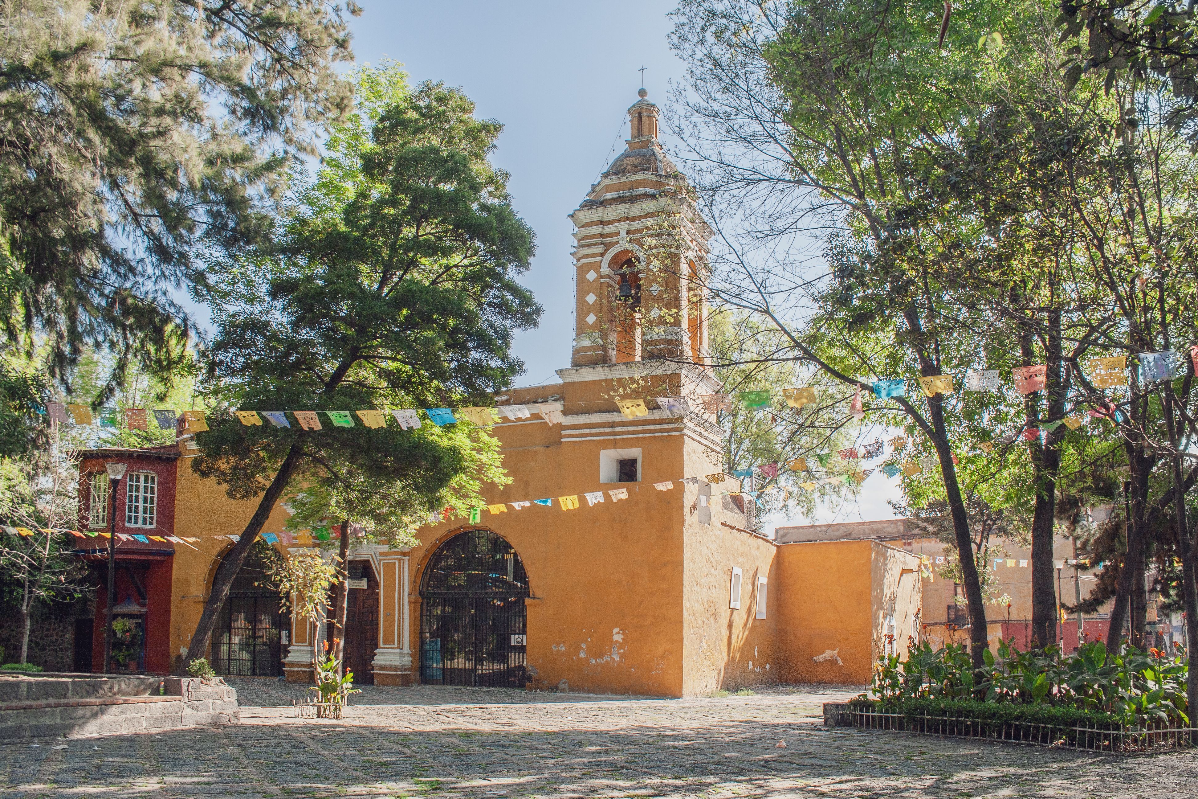 Charming view of the Chapel of Santa Catarina in Mexico City surrounded by greenery.