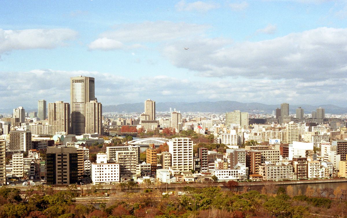 Osaka city skyline with modern architecture and autumn foliage