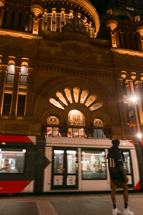 Tram Passing Historic Building at Night