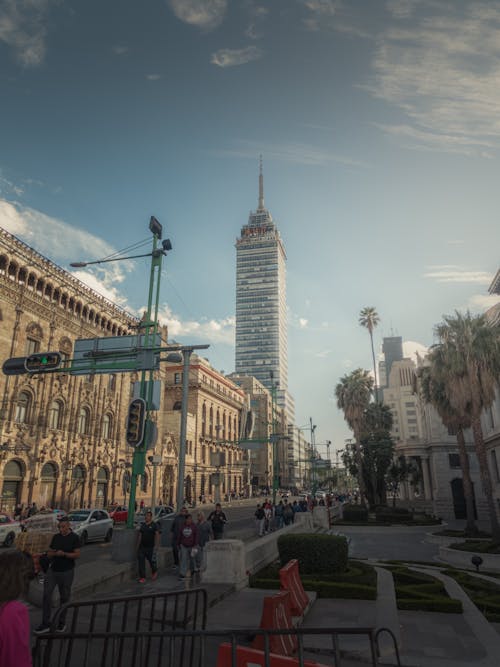 A city street with tall buildings and people walking