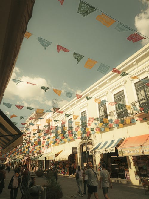 A street with colorful flags hanging from the buildings